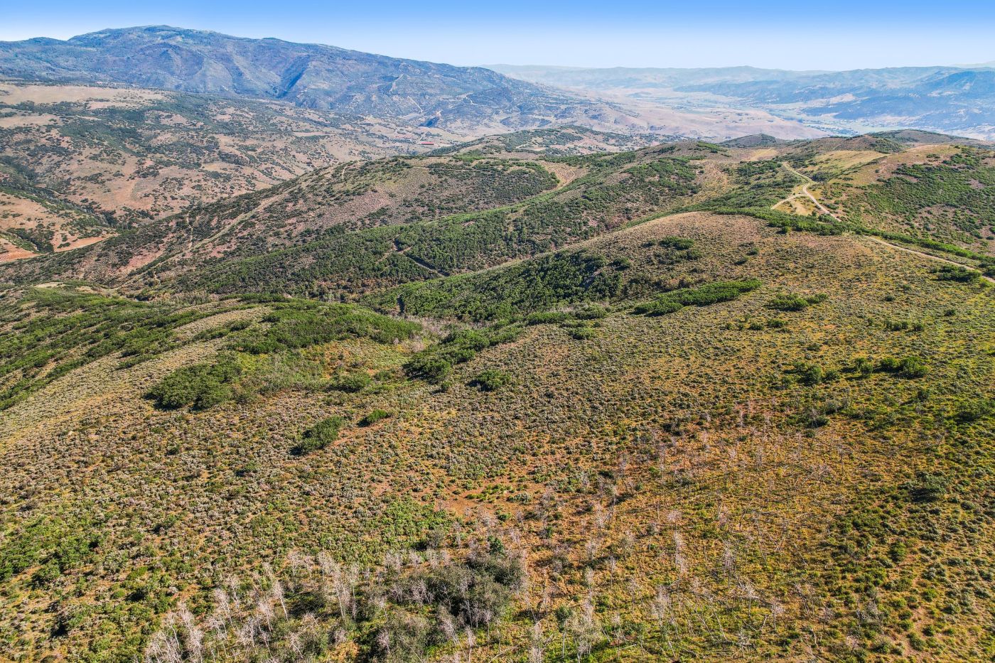 Aerial view of 124 acre Rockport Ranches property near Park City Utah with mountain views and open land