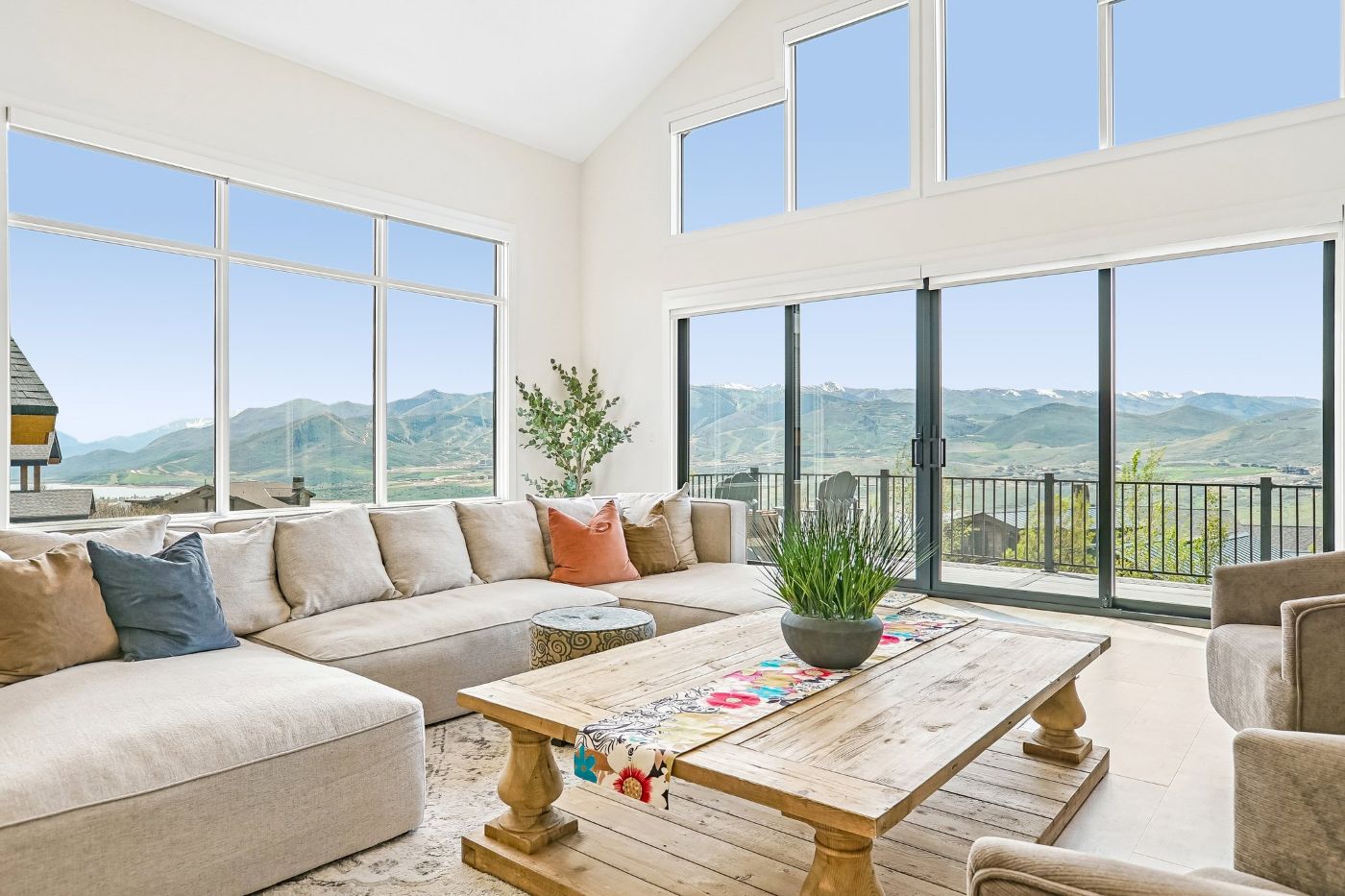 Open-concept living room with expansive windows framing Jordanelle Reservoir and Deer Valley views