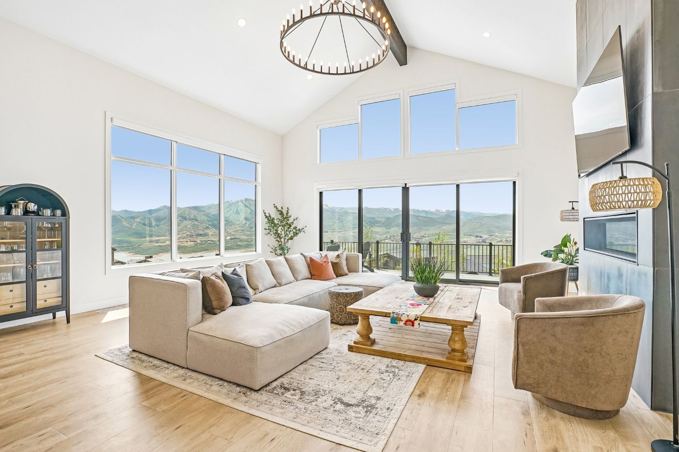 Open-concept living room in a Soaring Hawk at Hideout home with panoramic views of Jordanelle Reservoir and Deer Valley ski runs