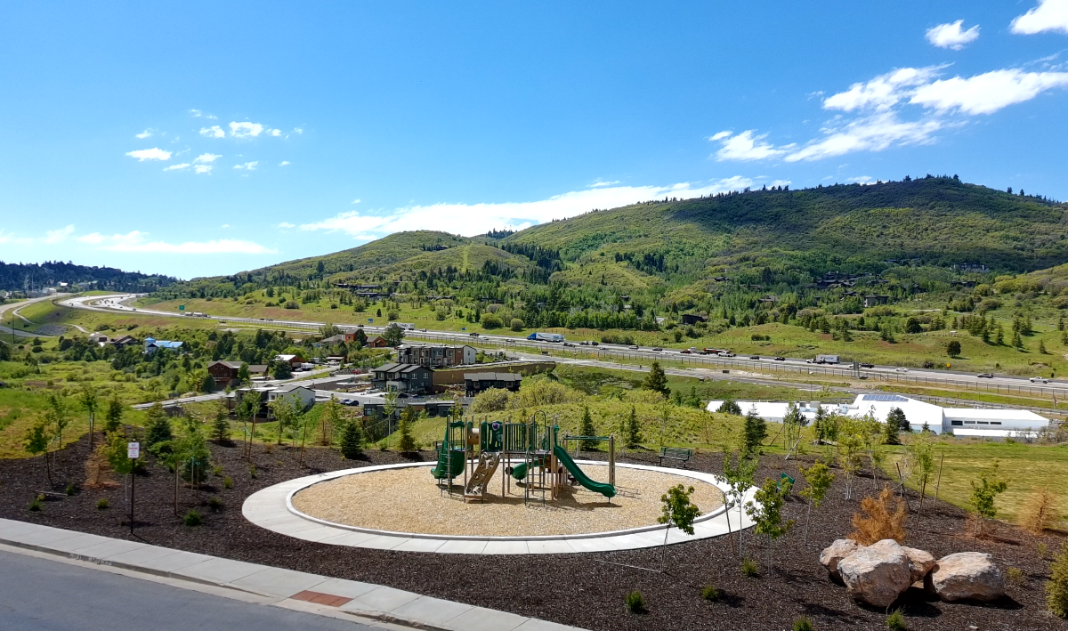 Aerial view of Discovery Ridge in Park City highlighting the neighborhood playground, open space, walking trails, and surrounding mountain landscape