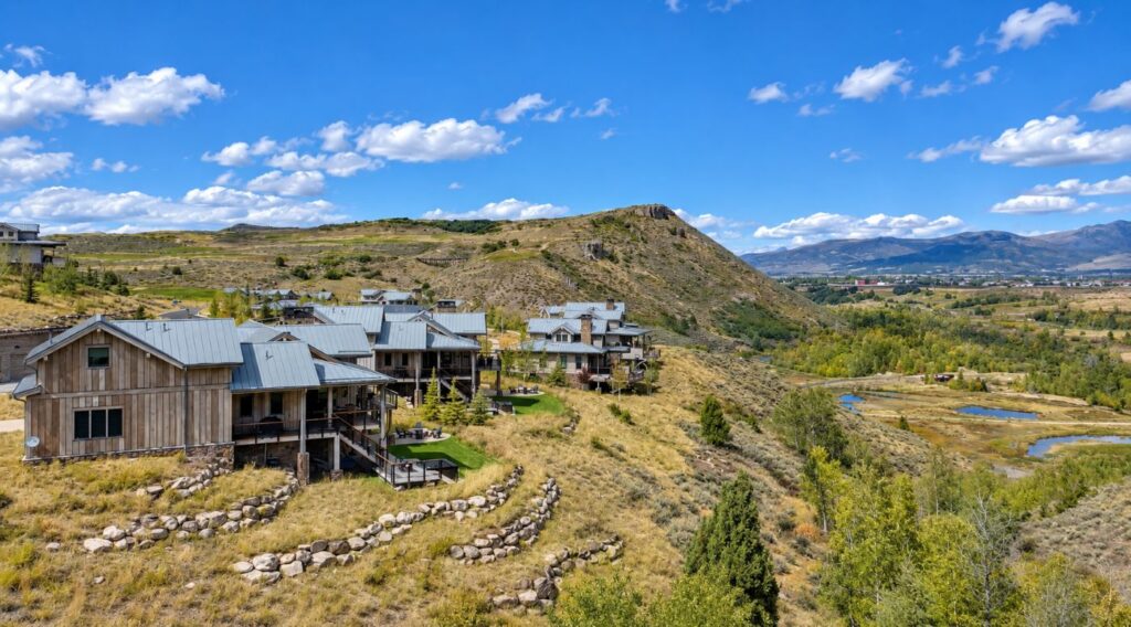 Aerial view of Victory Ranch Residence Club cabins overlooking the Upper Provo River and surrounding mountain landscape near Park City, Utah.