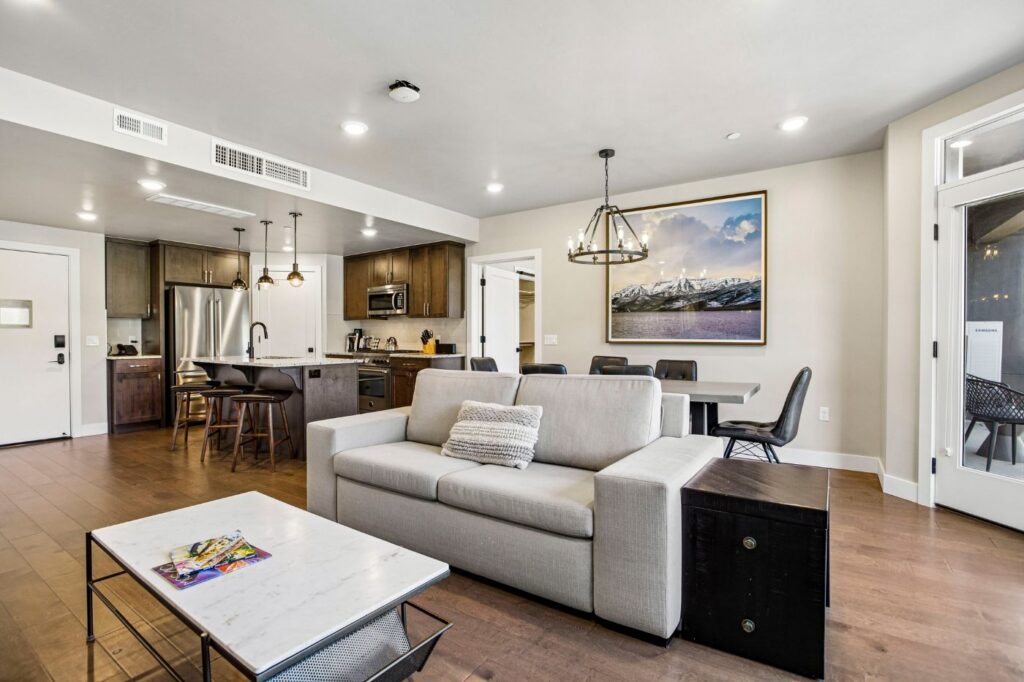 Contemporary living and dining space with large windows, fireplace, and mountain-inspired furnishings in Black Rock Mountain Resort Residence #508.