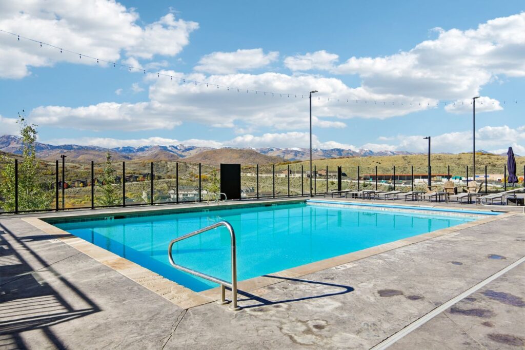 Heated outdoor swimming pool at Black Rock Mountain Resort with views of the surrounding Park City mountains.