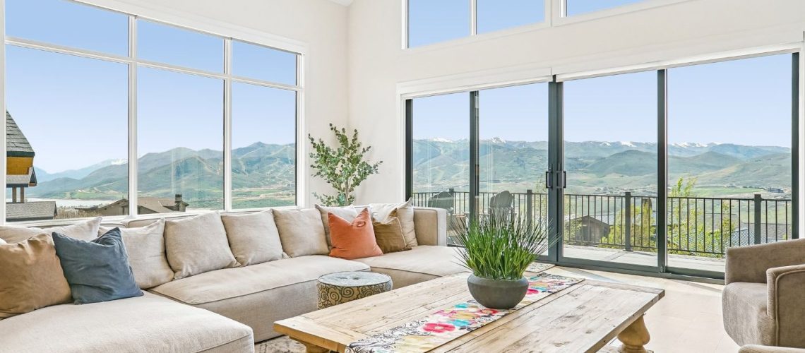 Open-concept living room with expansive windows framing Jordanelle Reservoir and Deer Valley views